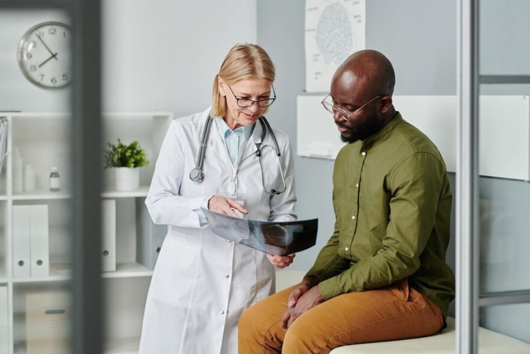 Oncologist explaining diagnostic results to a male cancer patient at CurePoint Cancer Center