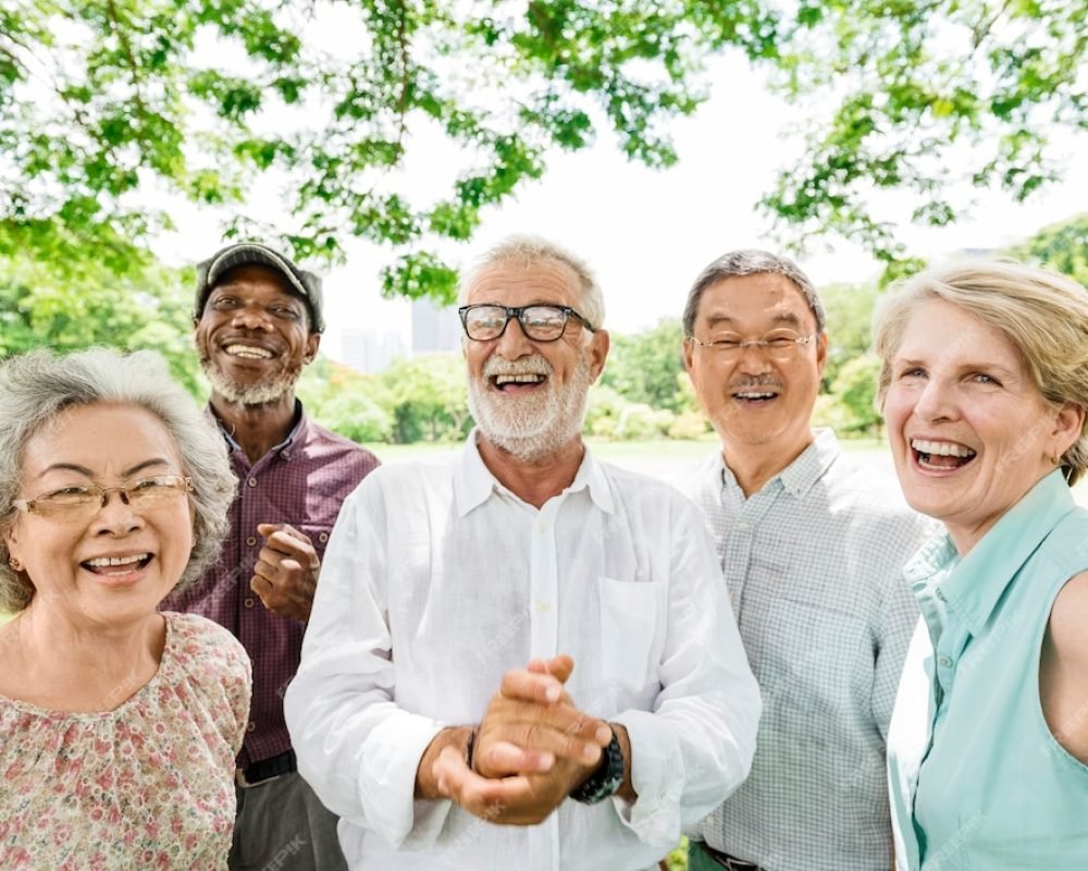 Group of joyful senior cancer survivors celebrating life and wellness after treatment at CurePoint Cancer Center.